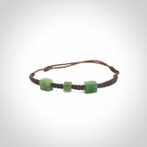 Hand carved New Zealand jade adjustable bracelet with brown cord. Carved in New Zealand jade by Ric Moor for NZ Pacific. One only armband for women and men.